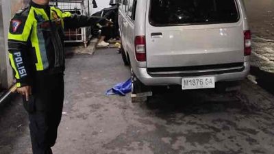 Anggota Satlantas Polresta Sidoarjo Menunjukan Mobil Carry yang Sempat Terguling di Jalan Raya Waru