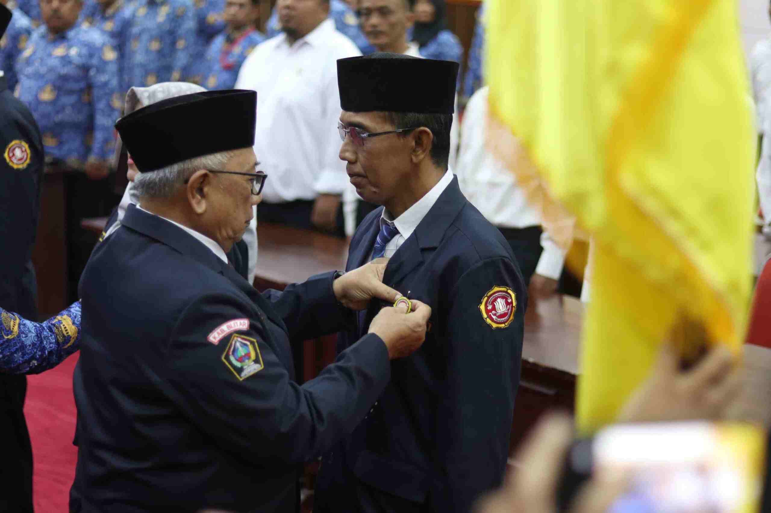 Karang Taruna Kabupaten Blitar Dikukuhkan, Mitra Strategis Pemerintah di Bidang Sosial Bupati Blitar Drs Rijanto MM saat Menyematkan PIN dalam Pengukuhan Karang Taruna Kabupaten Blitar scaled
