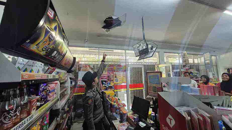 Polisi Menunjukkan Atap Alfamart di Desa Sidorejo Kecamatan Ponggok Kabupaten Blitar yang Dibobol Maling